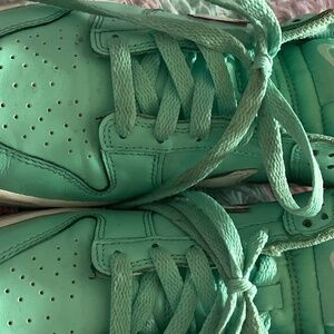 A pair of teal Nike dunks